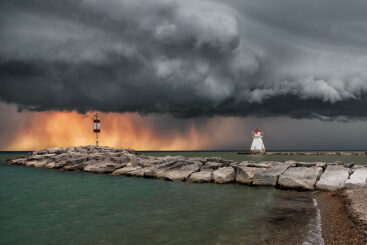 Sunlit thunderstorm over Southampton lighthouse on Lake Huron